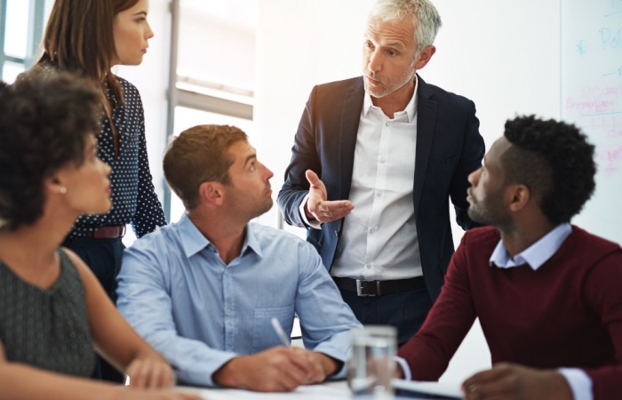 business people sitting in a board room having a discussion